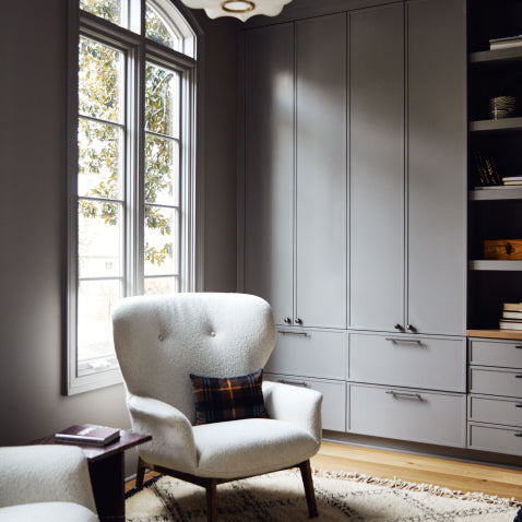 Grey living room with boucle arm chair and antique brass hardware