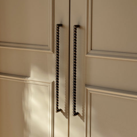 Cream wardrobe doors with antique brass bobbin handles